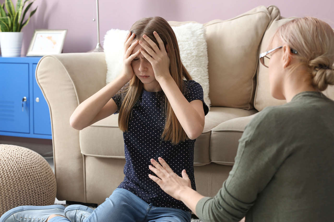 A psychologist working with a stressed and anxious teenager